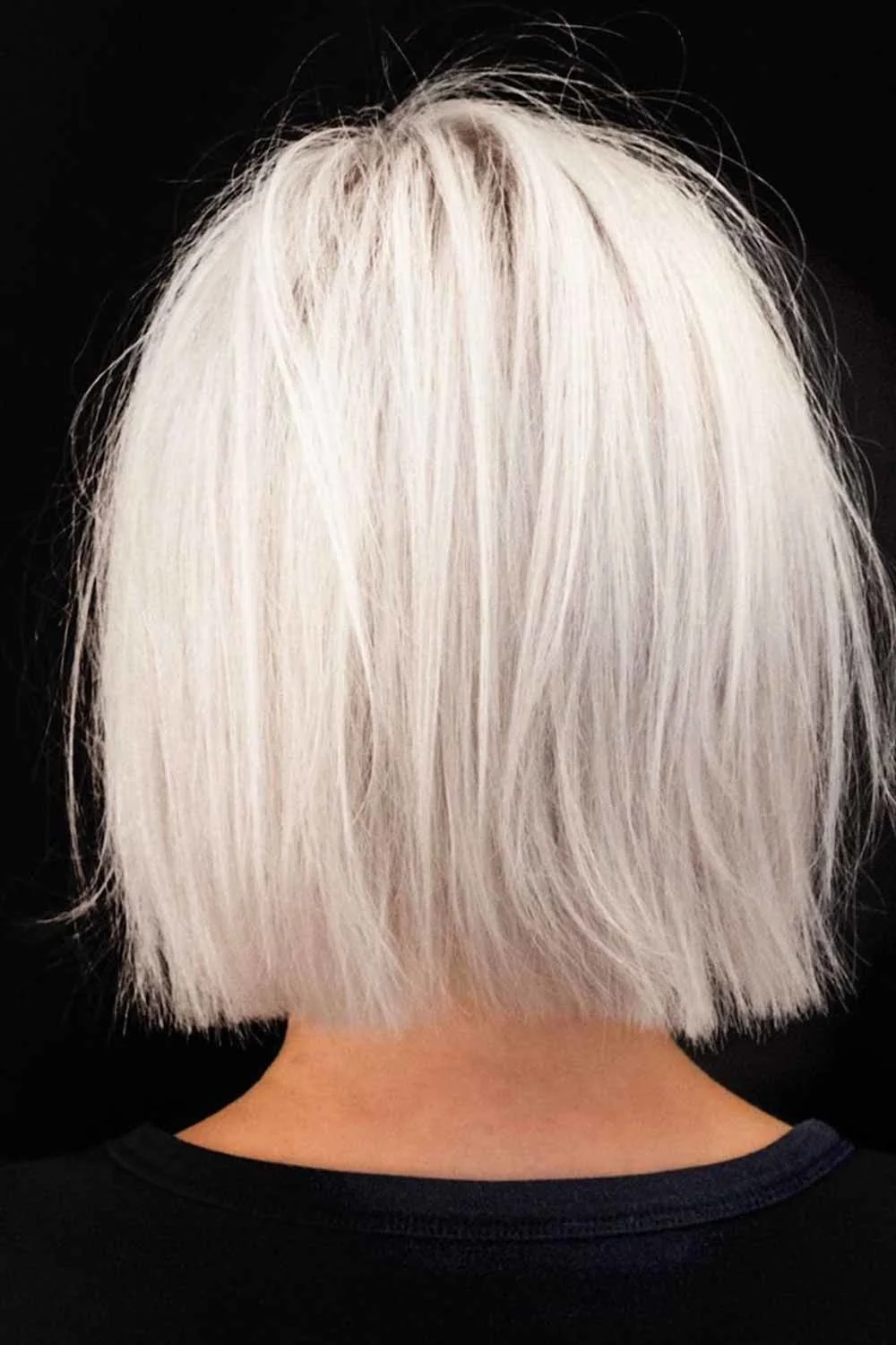 Back view of a pale blonde bob with a blunt-looking perimeter