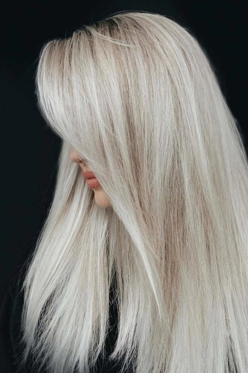 Side view of creamy very light blonde hair falling straight