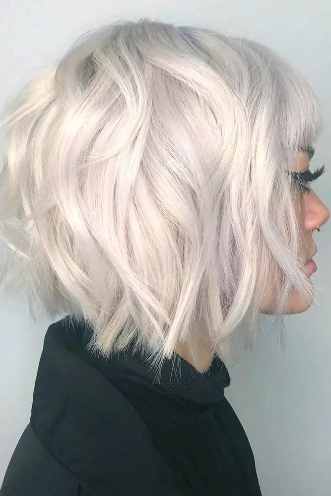 Side view of a textured white-blonde bob with loose separated ends