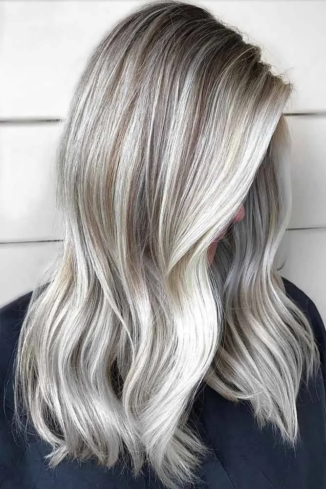 Side view of silver-blonde ribbons through darker-rooted waves