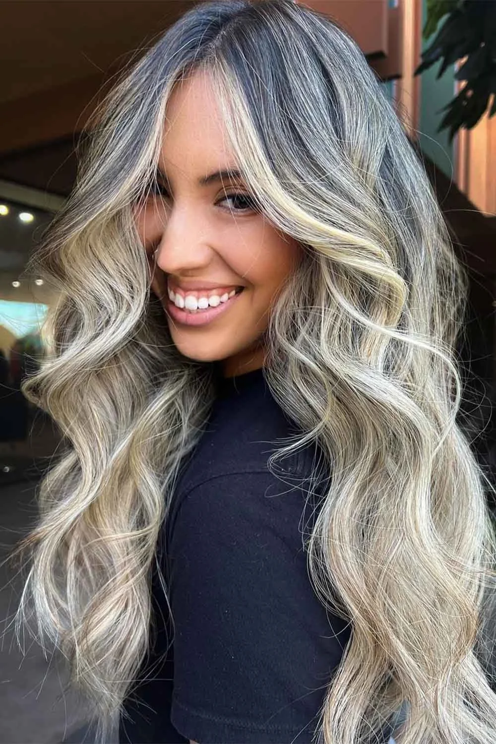Long silver-blonde waves with a dark root and bright front sections