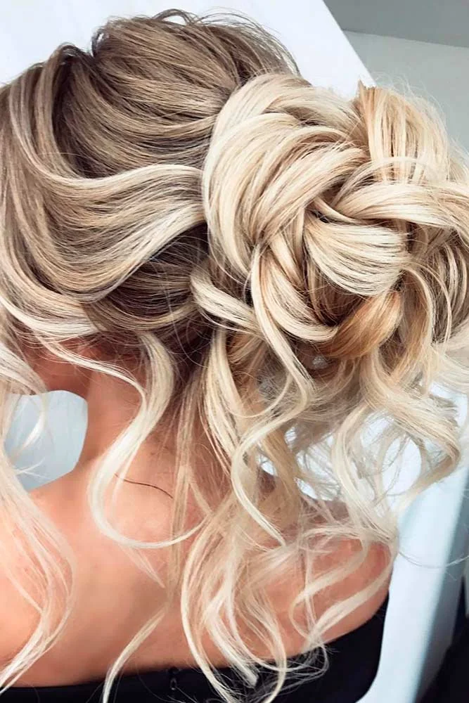 Two-tone hair arranged in a high looped bun with pale sections near the face