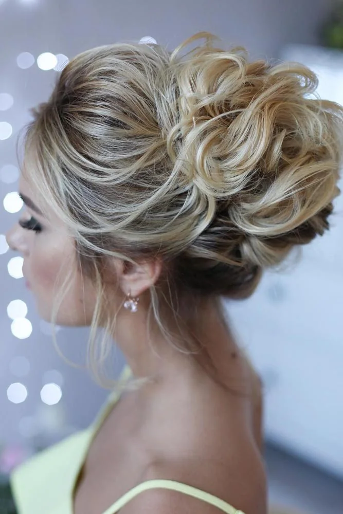 Cool blonde hair arranged in a low bun with broad soft loops