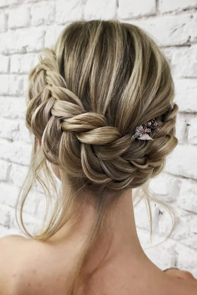 Ashy blonde hair with a broad braided band feeding into a low textured bun