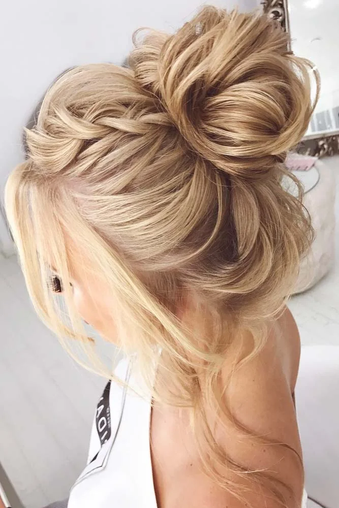 Blonde hair in a loose topknot with long face-side strands