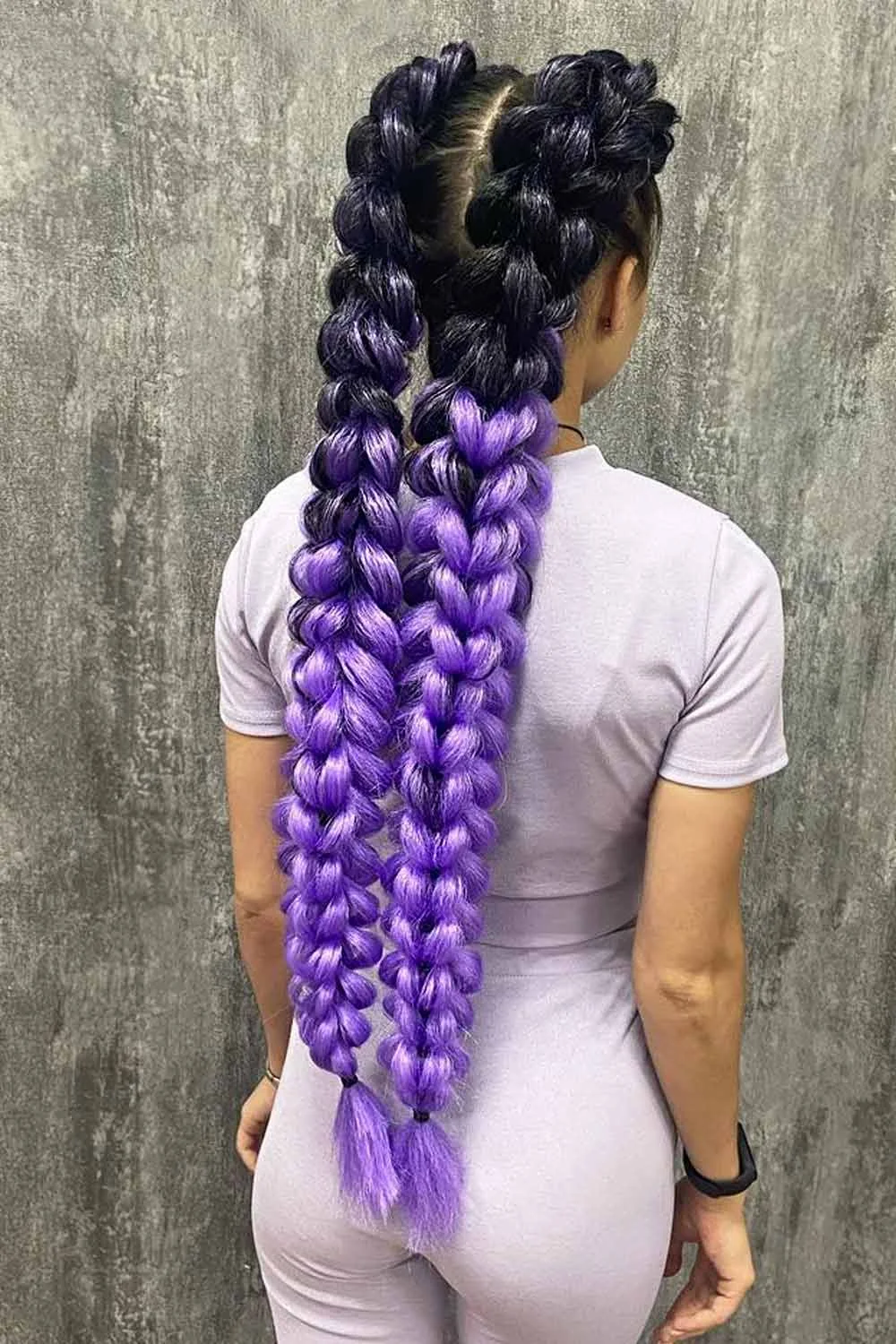 Back view of two very long dark-to-violet braids with broad rounded loops