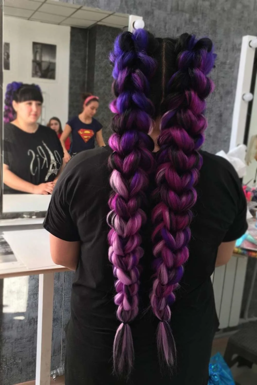 Back view of two long purple braids with dark upper sections and violet lower loops