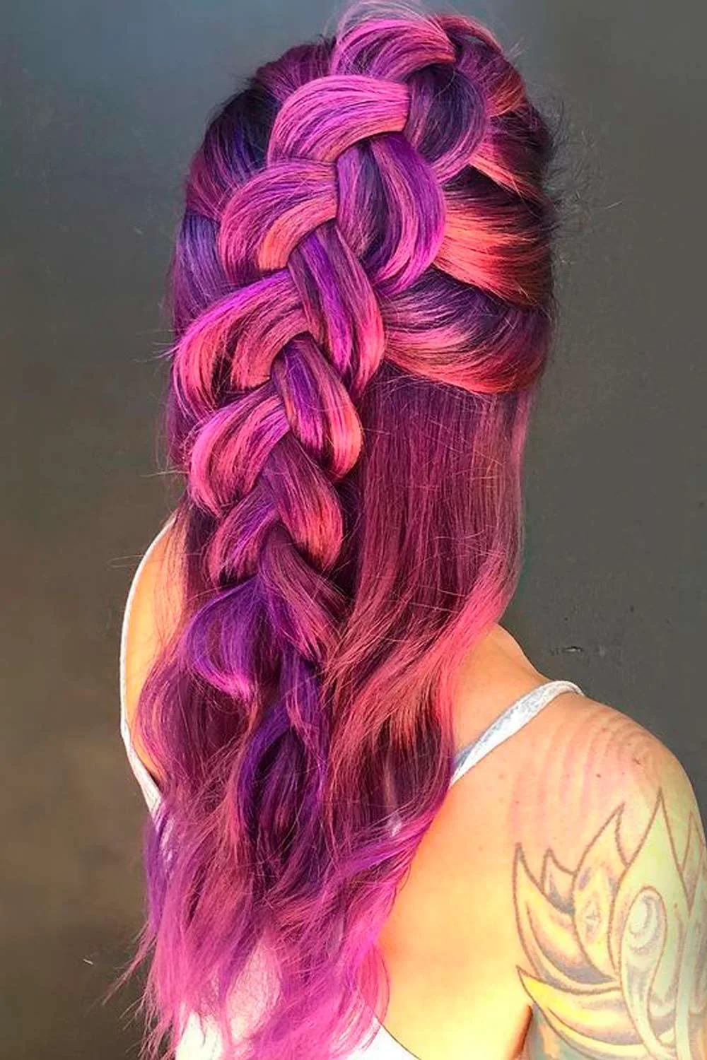 Back-side view of a large purple braid with bright pink strands around the crossings
