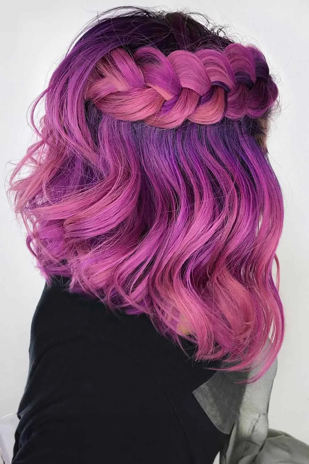 Back-side view of a purple-pink bob with a broad braid across the upper back