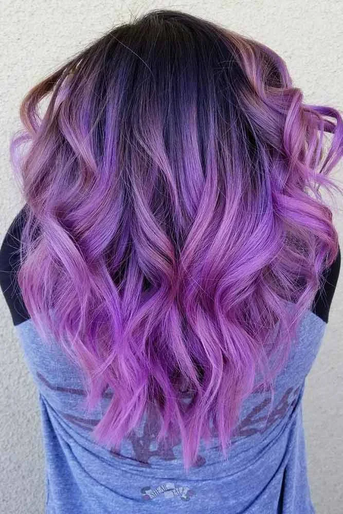 Back view of long wavy hair with a dark crown blending into lavender and lilac lengths