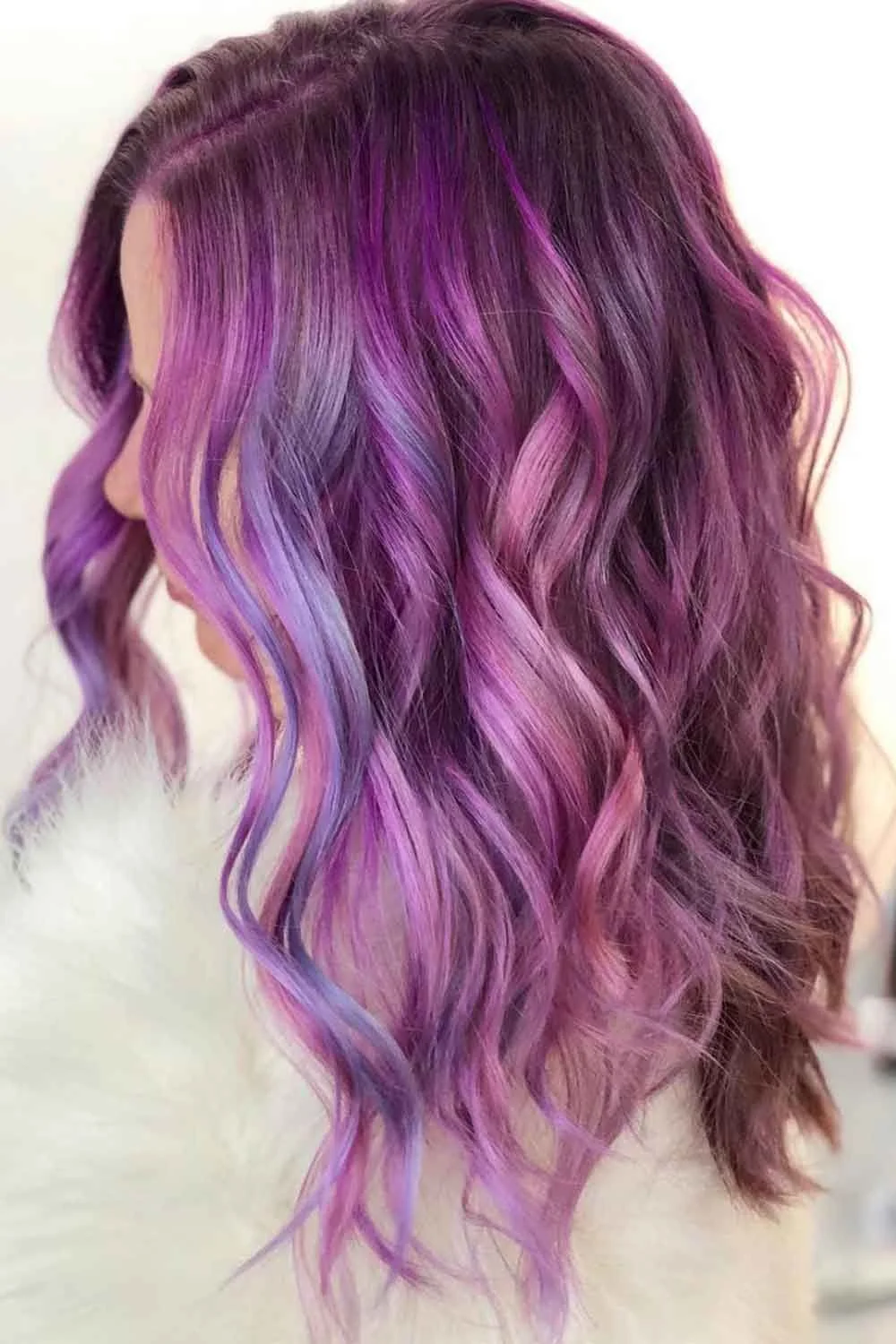 Side view of shoulder-length loose waves colored dusty mauve and soft purple