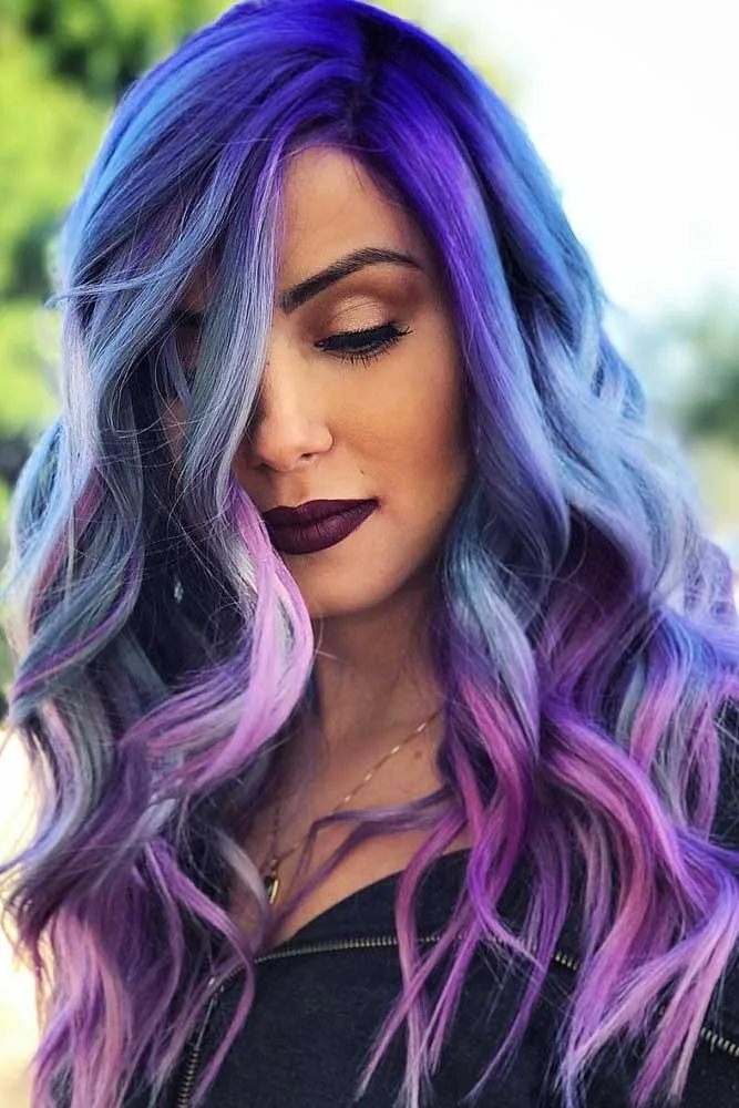 Woman with long loose waves colored indigo blue, violet, and pale pink around the face
