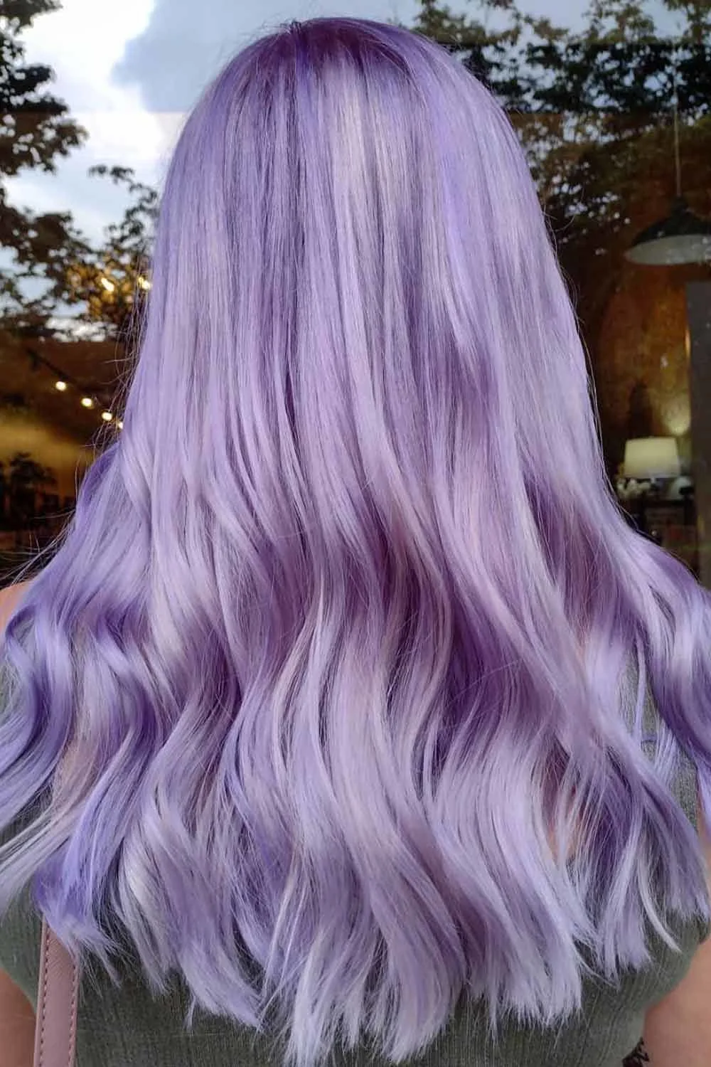 Back view of long hair with a soft lavender wash and loose waves through the lower layers