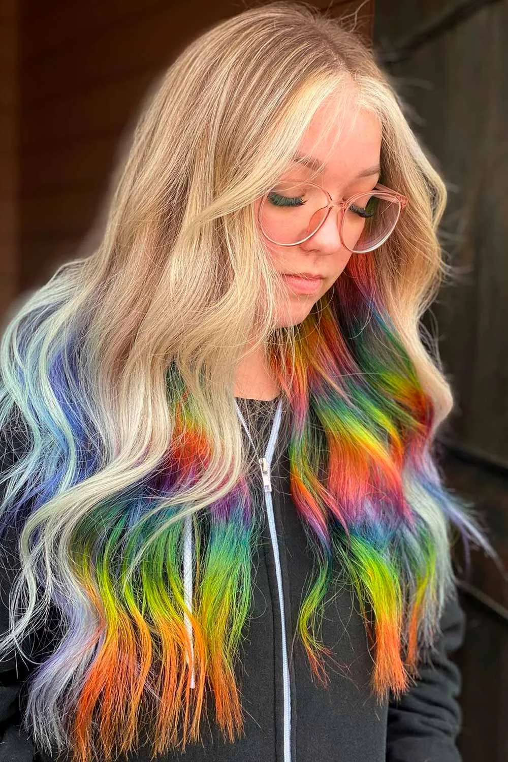 Front-side view of long blonde waves with blue, green, yellow and orange lower sections