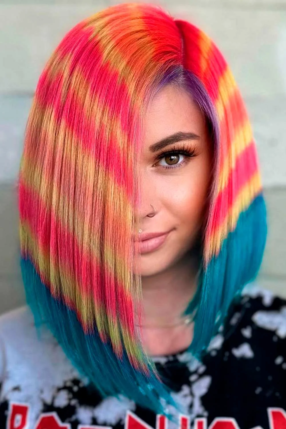 Front portrait of a straight angled bob with pink-yellow bands and teal ends