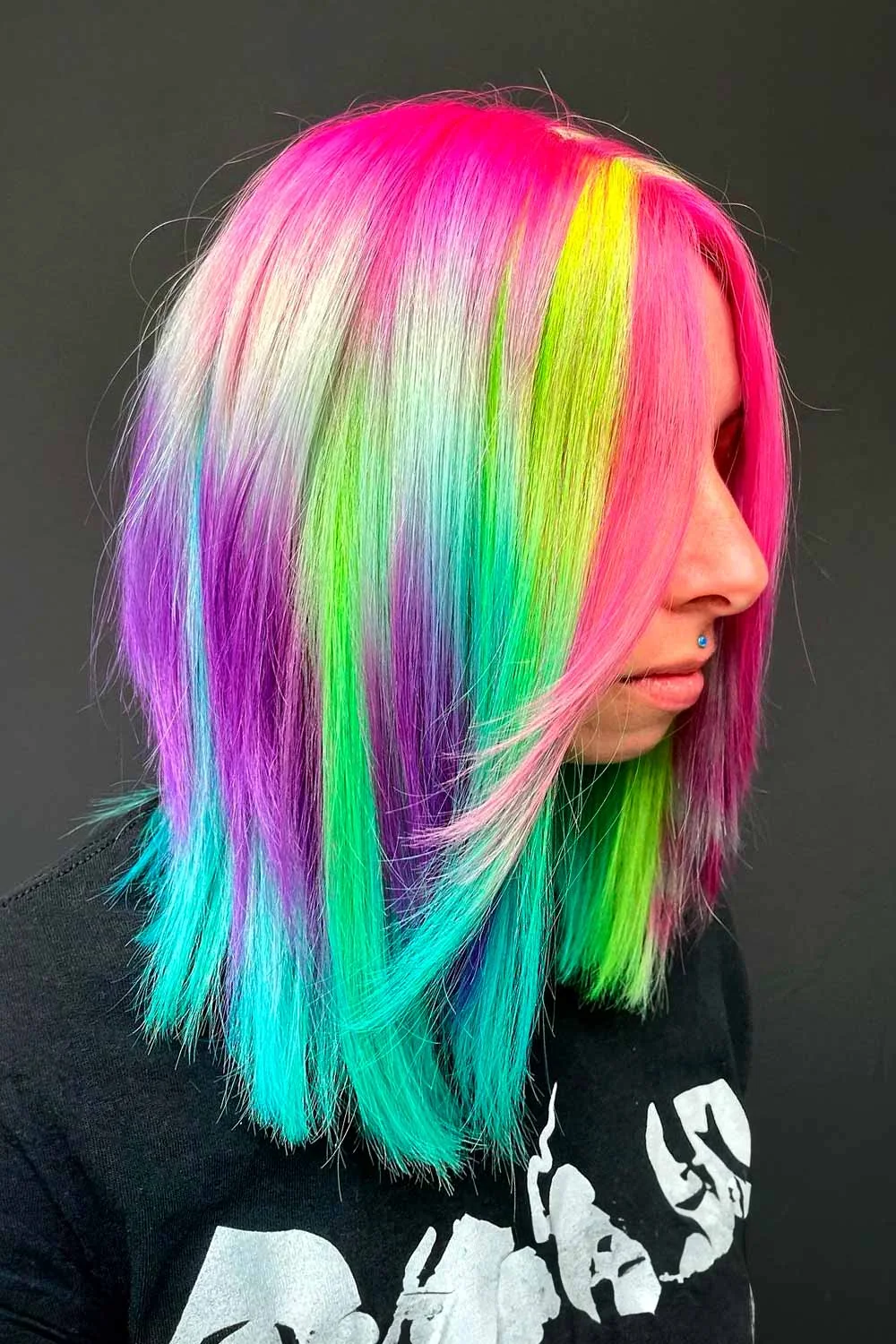 Side view of a straight lob with pink crown, pale center panels and turquoise ends