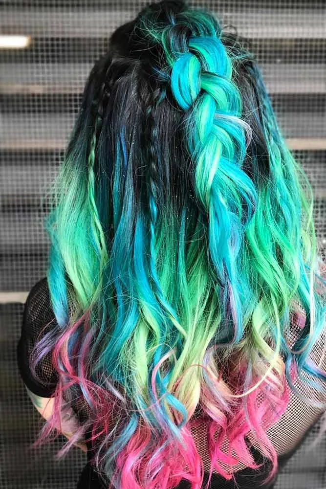 Back view of long dark-rooted hair with a teal center braid and green-to-pink lower waves