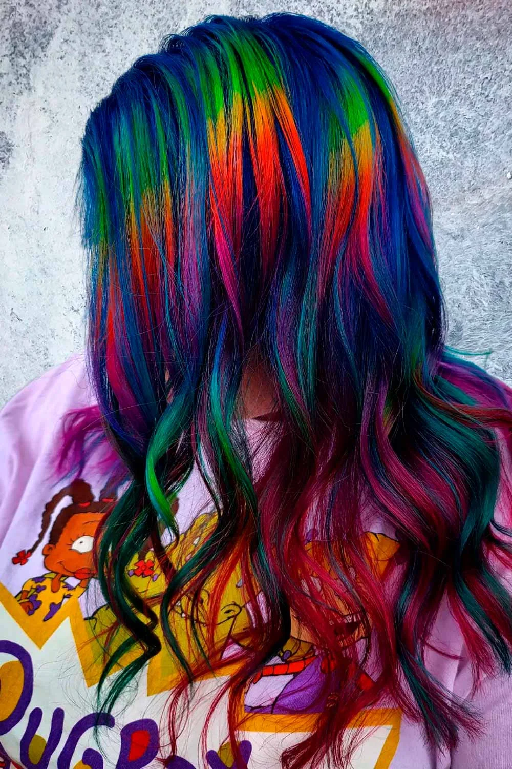Back view of long deep-blue waves with green, orange, red and magenta color ribbons