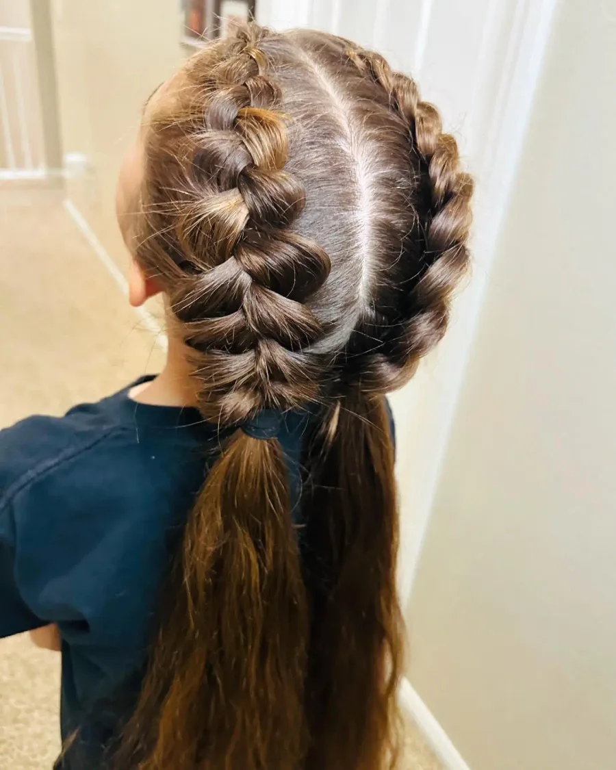 Back view of a single school braid with loose ends on long straight hair