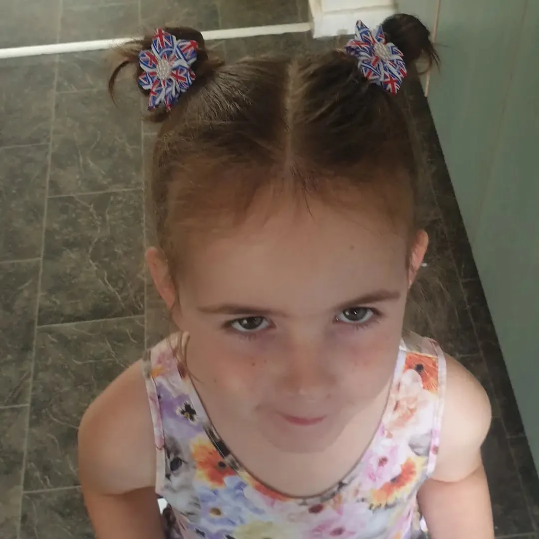 shoulder straight brunette bun shown as a school hairstyles idea, featuring center part