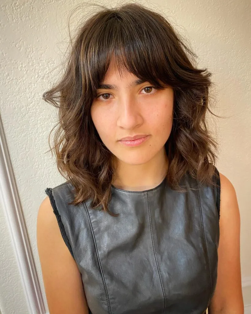 shoulder wavy brunette shag with curtain fringe shown as a shag hairstyles for medium length thin fine hair idea