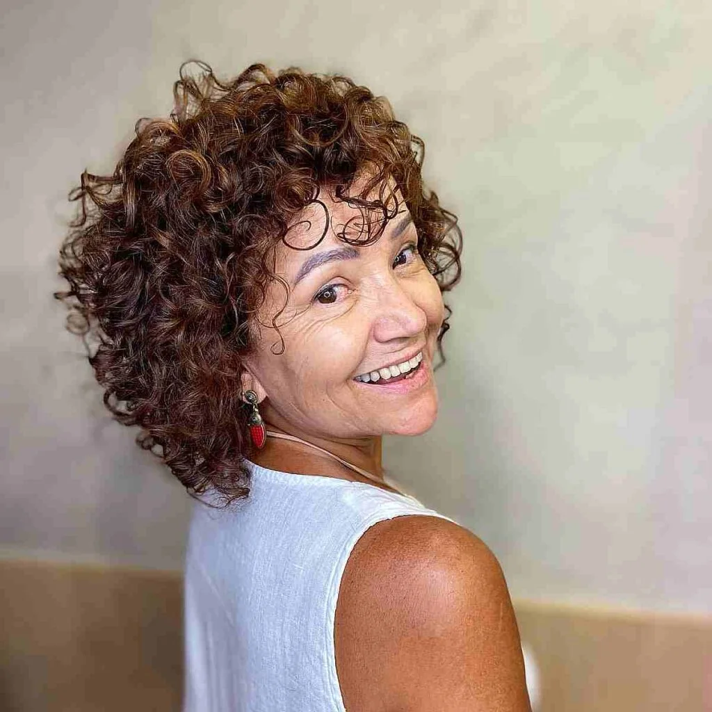 shoulder curly brunette shag with curly fringe fringe shown as a shaggy hairstyles for women over 50 idea, featuring curly fringe fringe