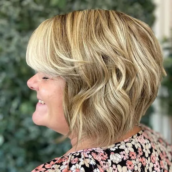 shoulder wavy silver shag with curtain fringe shown as a shaggy hairstyles for women over 50 idea, featuring shoulder outline