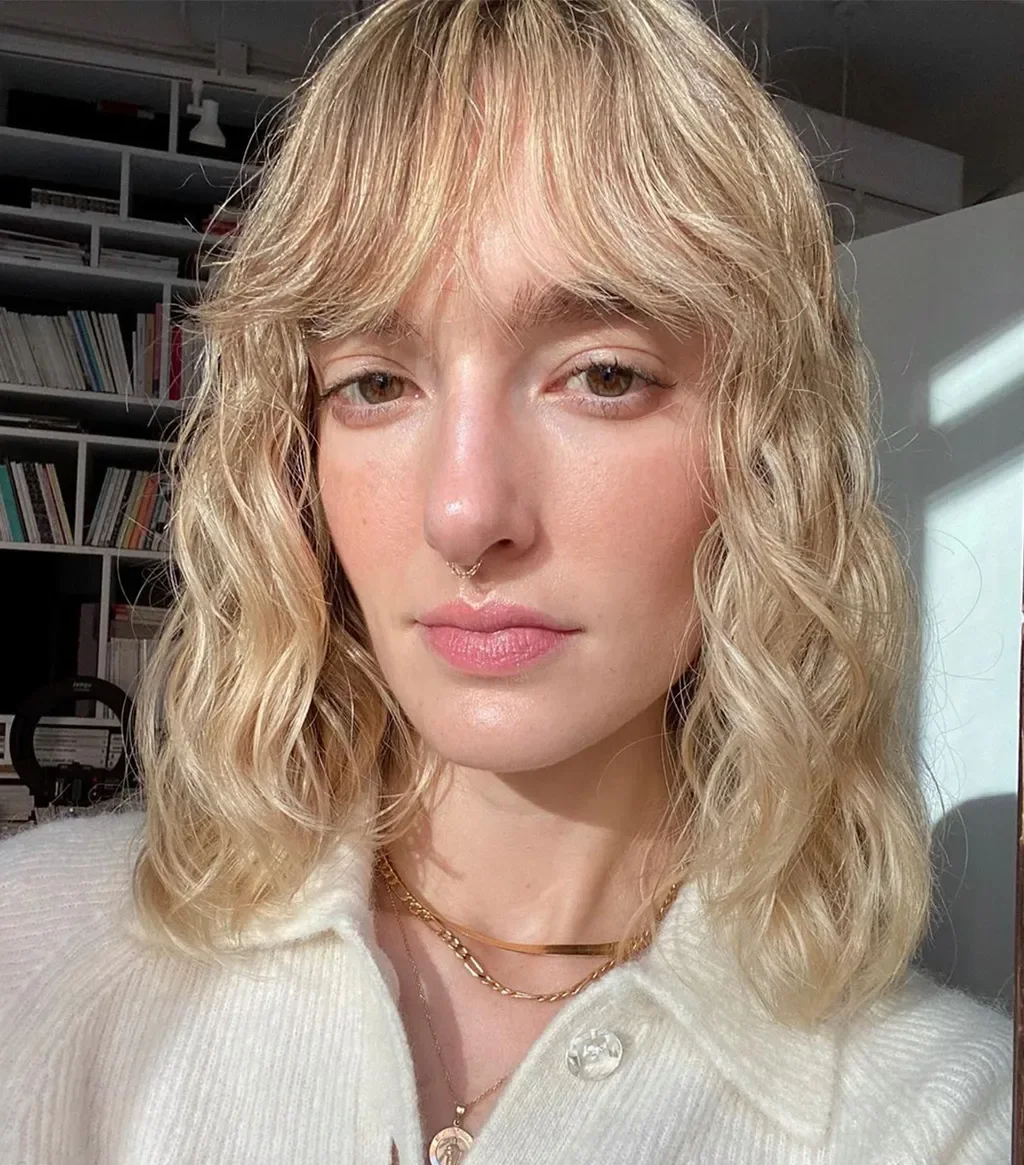 medium curly blonde shag with curly fringe fringe shown as a shaggy lob idea