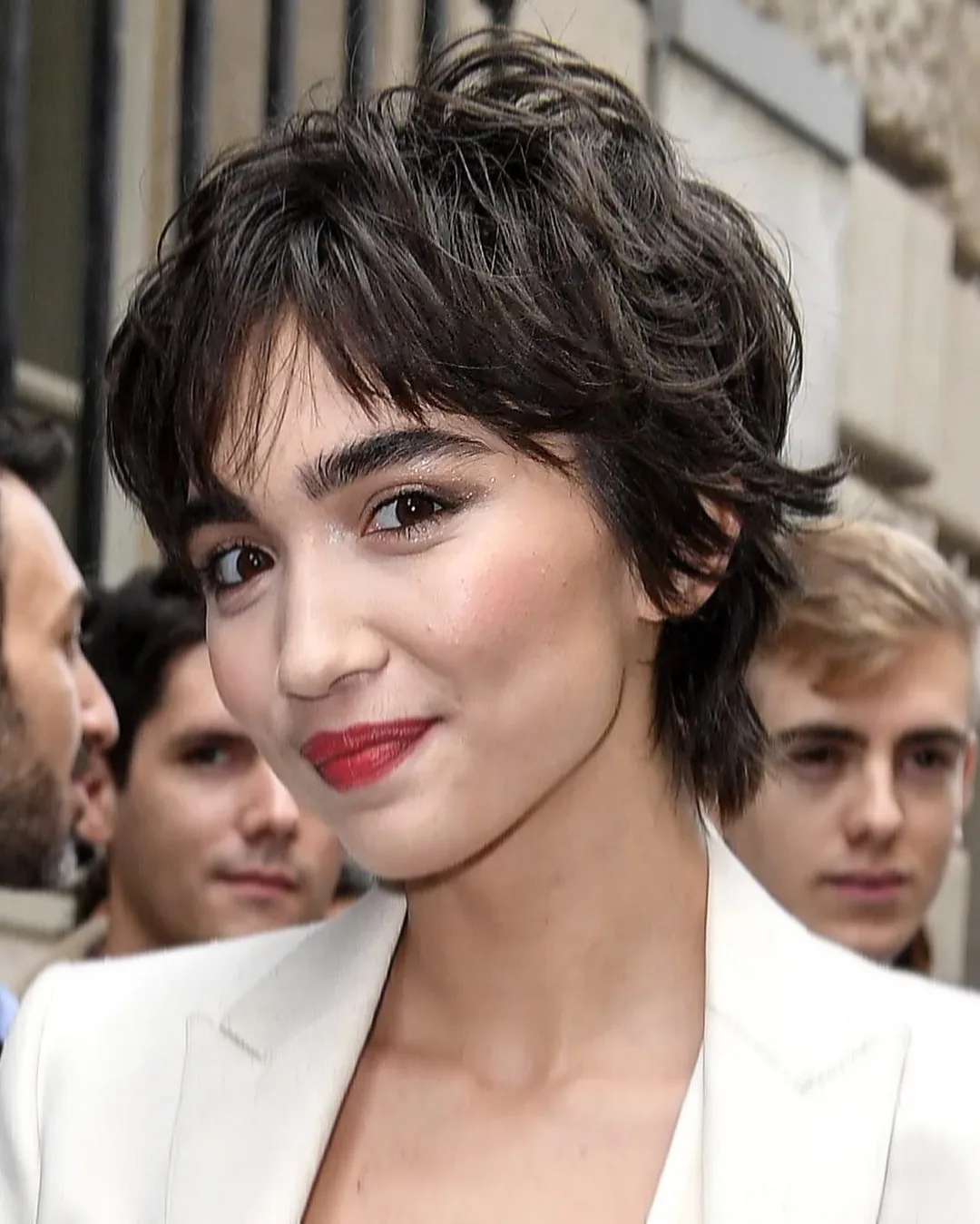 ear wavy black pixie with wispy fringe shown as a shaggy pix mullet idea