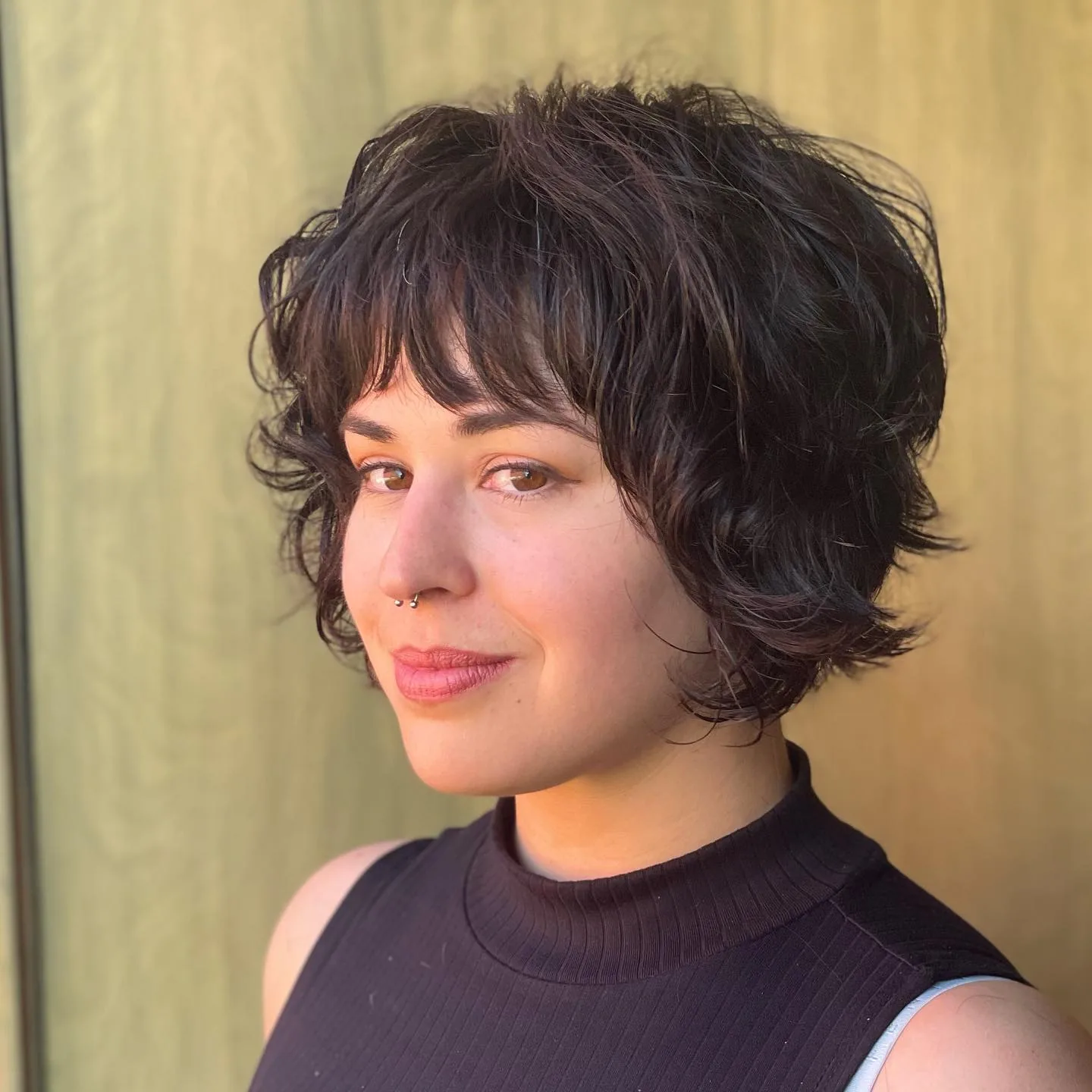 ear curly brunette pixie with curly fringe fringe shown as a shaggy pix mullet idea