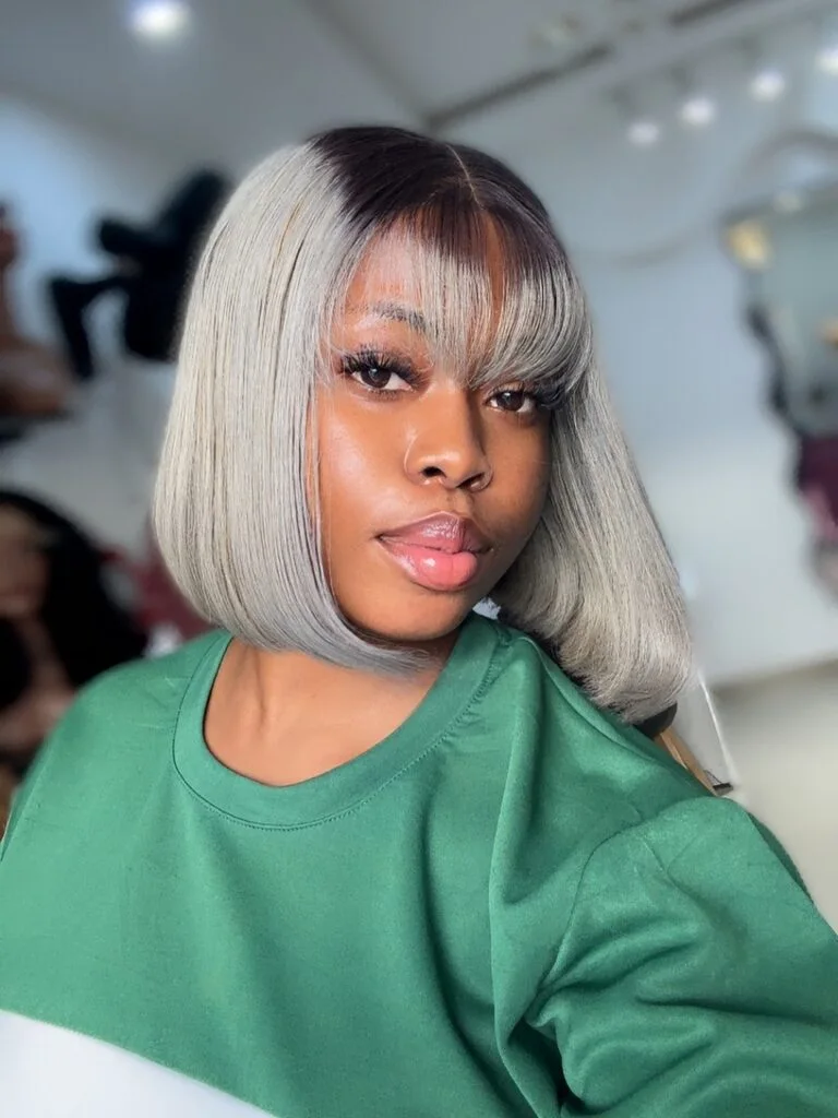 Short silver bob with a long side fringe and clean fine-hair shape