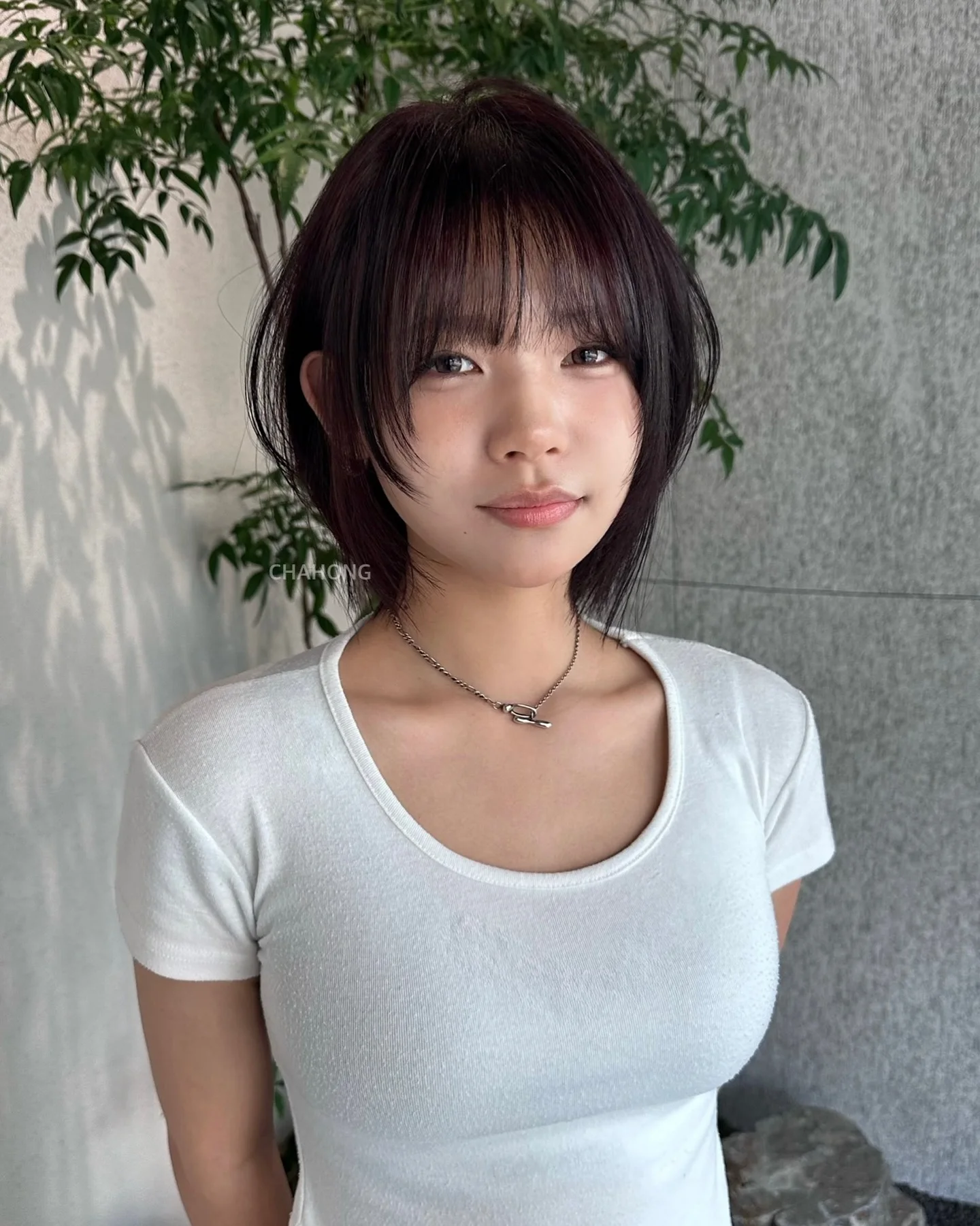 Dark tousled short bob with soft bangs and piecey ends