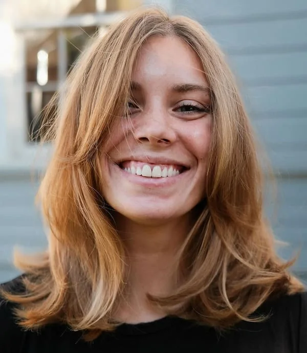 shoulder wavy chestnut lob with curtain fringe shown as a short butterfly haircuts idea