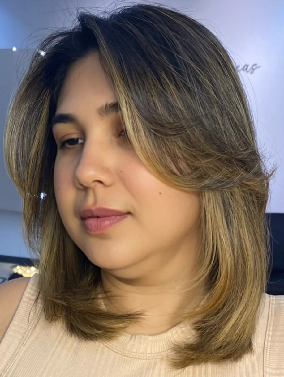 shoulder wavy chestnut lob with curtain fringe shown as a short butterfly haircuts idea, featuring glossy finish