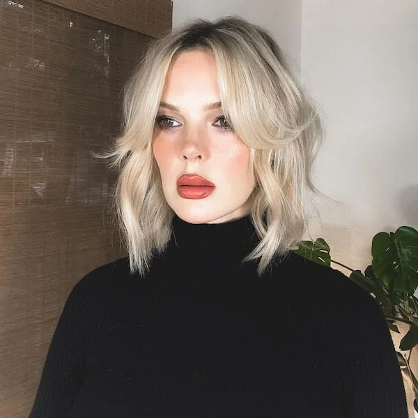shoulder wavy honey lob with curtain fringe shown as a short butterfly haircuts idea