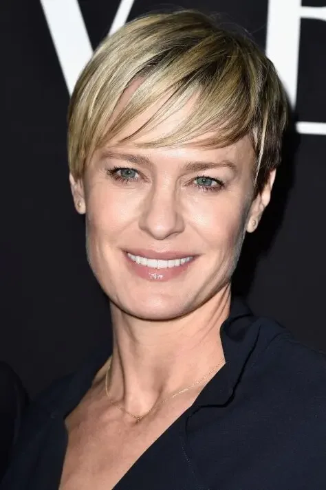 Side-swept blonde pixie haircut with light volume for fine hair
