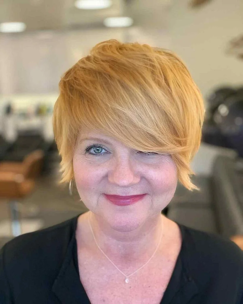 Blonde side-swept pixie with a longer front for fine hair