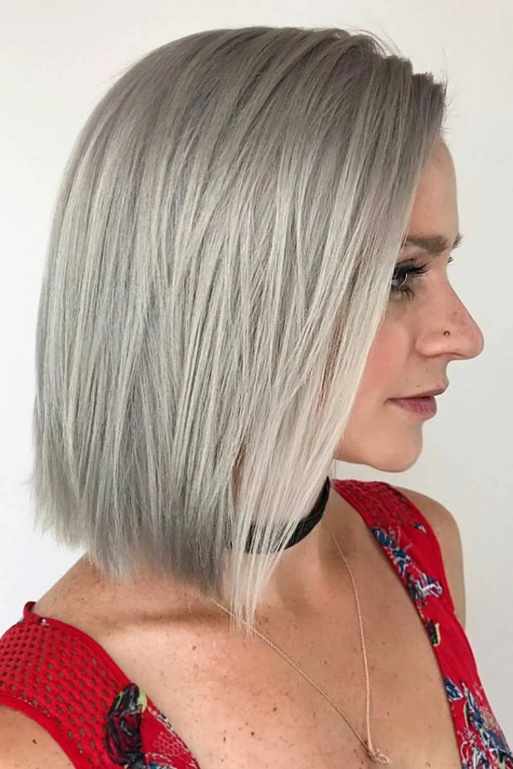 Side view of a straight silver bob with a slightly longer front section