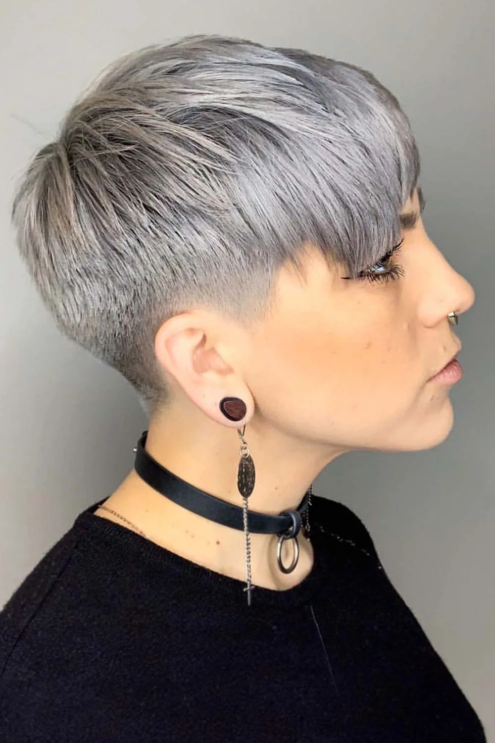 Side view of a short gray crop with closely cut sides and a longer forward fringe