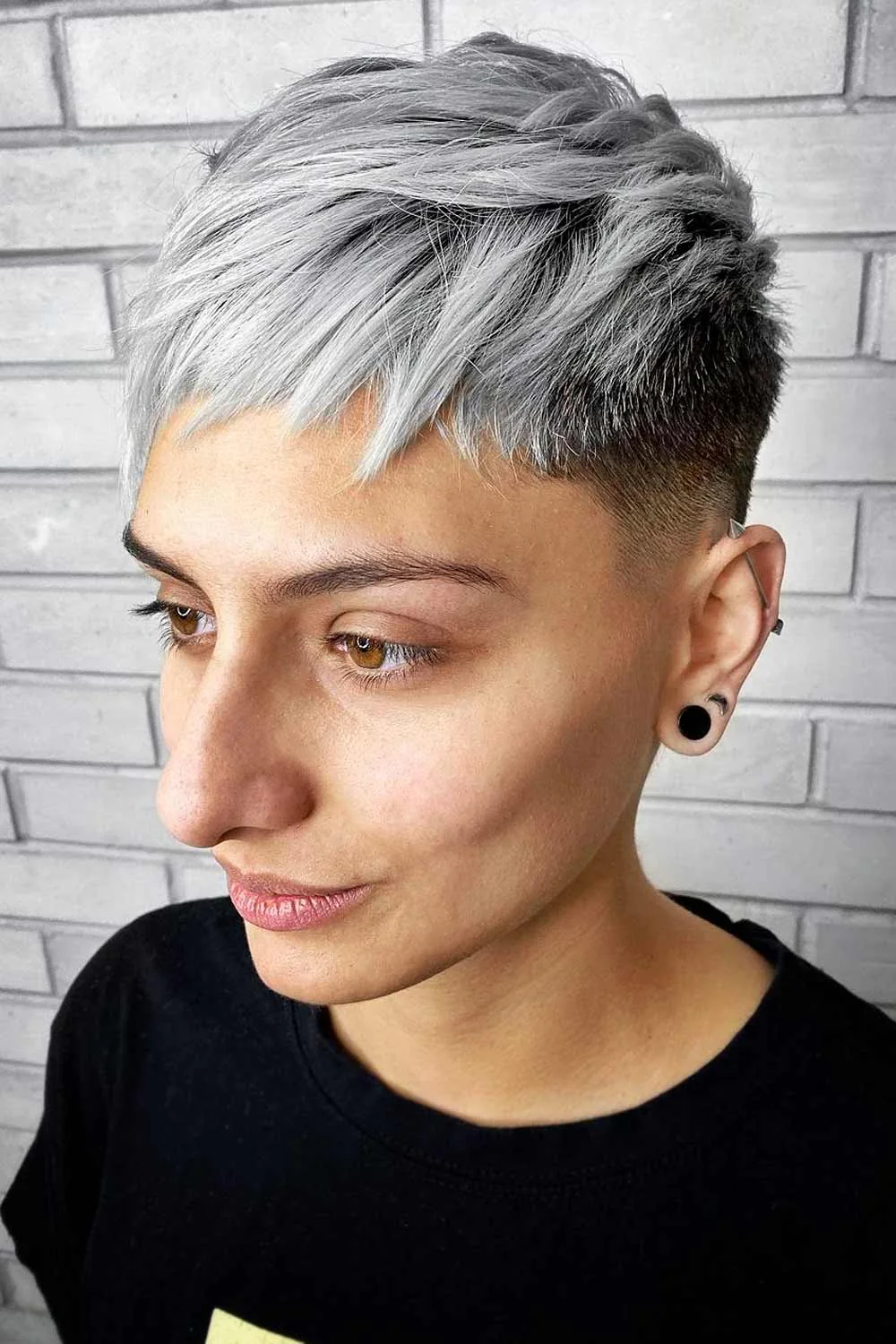 Front-side view of a gray pixie with a choppy fringe and close dark sides