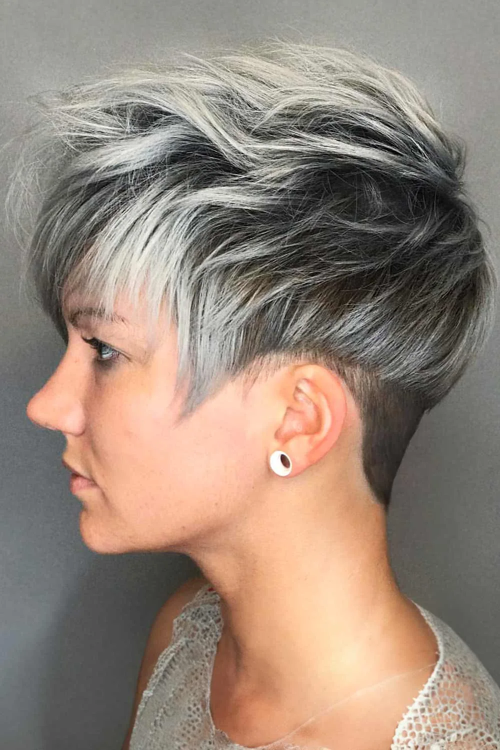 Side view of a swept gray pixie with dark depth and a close back