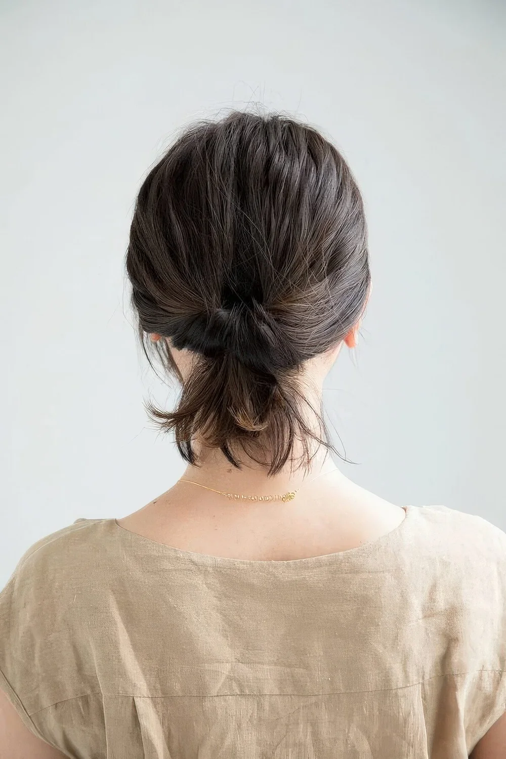 Wrapped loop ponytail with a messy top.