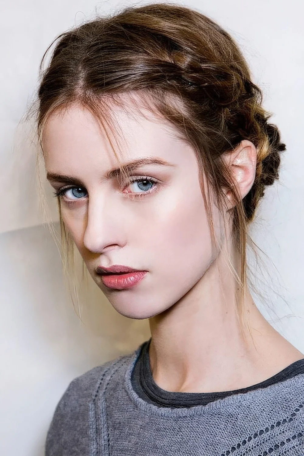 Short hair styled with side braids ending in a low bun and with some locks down.