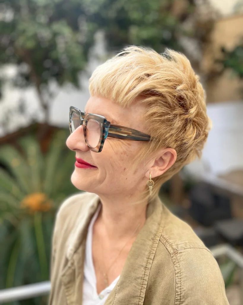 ear straight blonde pixie with side swept fringe shown as a short haircuts for women over 60 idea