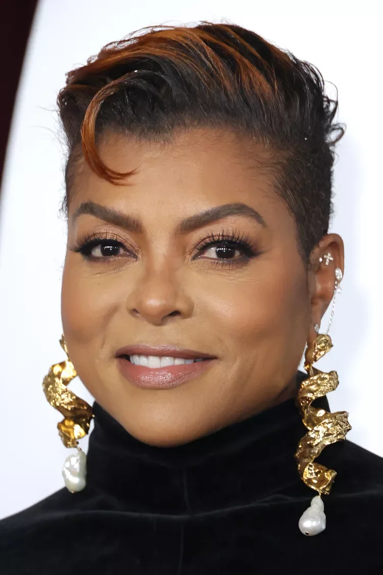 Older Black woman with a short pixie and copper-tipped lifted front