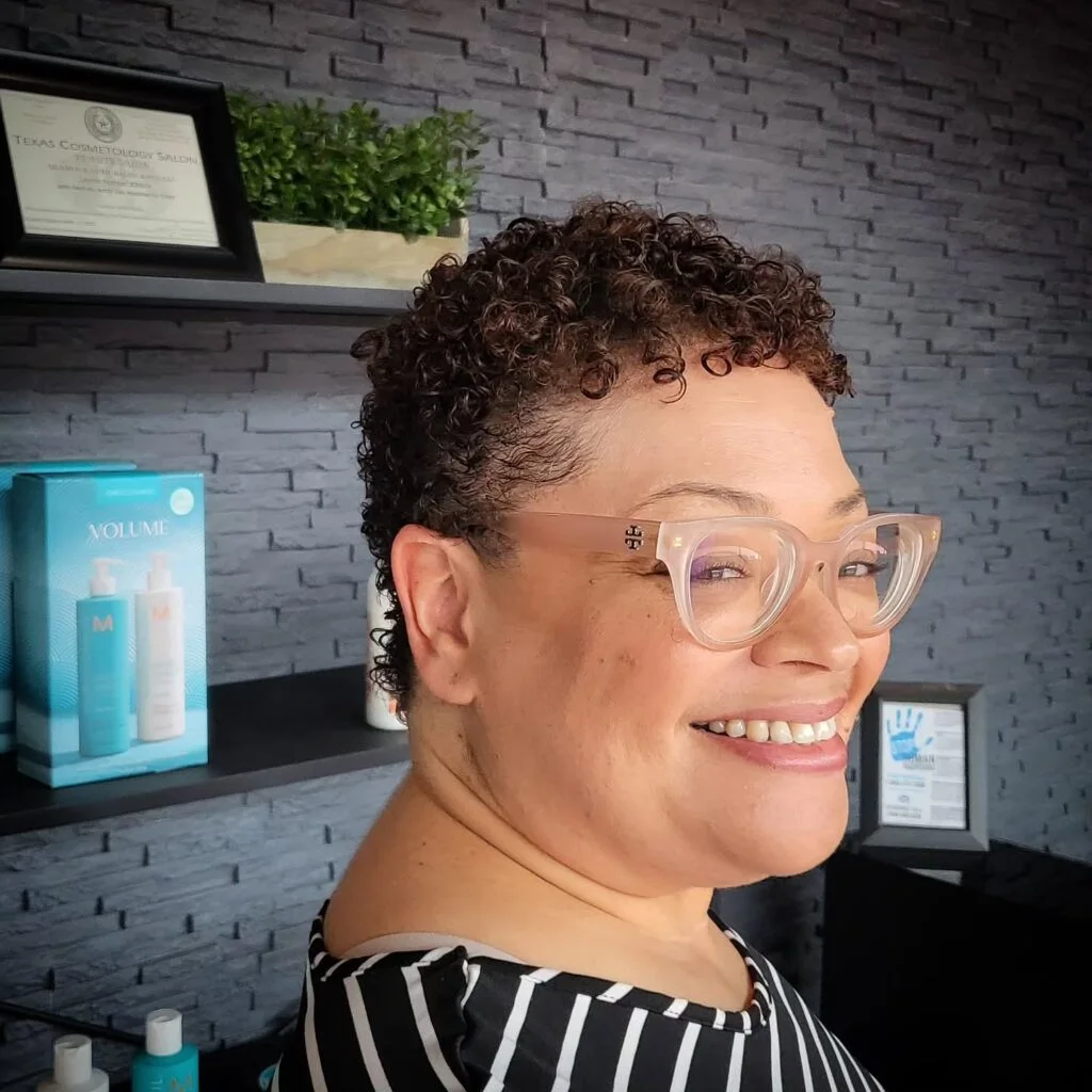 Older Black woman with a short curly tapered crop and soft side shape