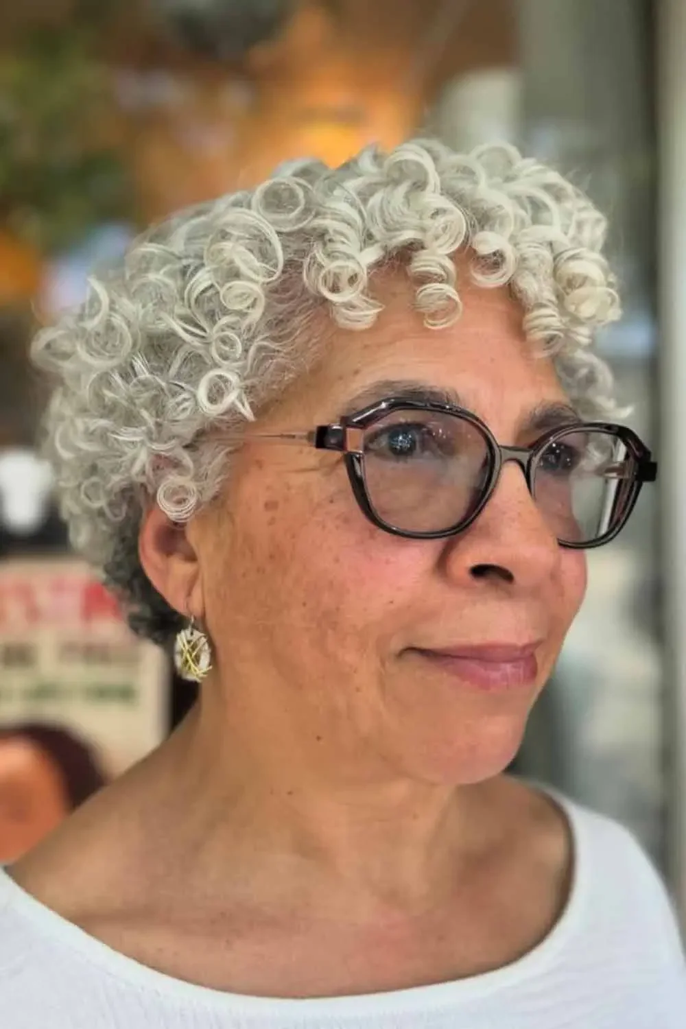 Older Black woman with short silver curls and glasses