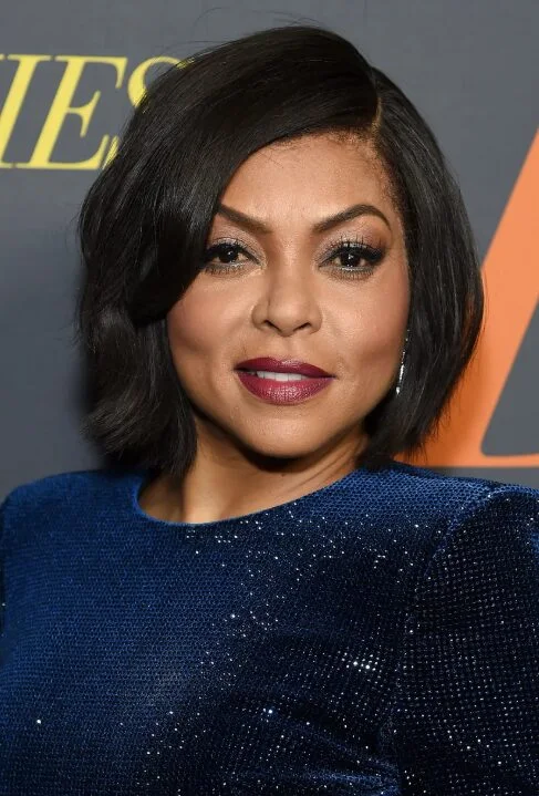 Older Black woman with a side-parted wavy bob and soft face-framing volume