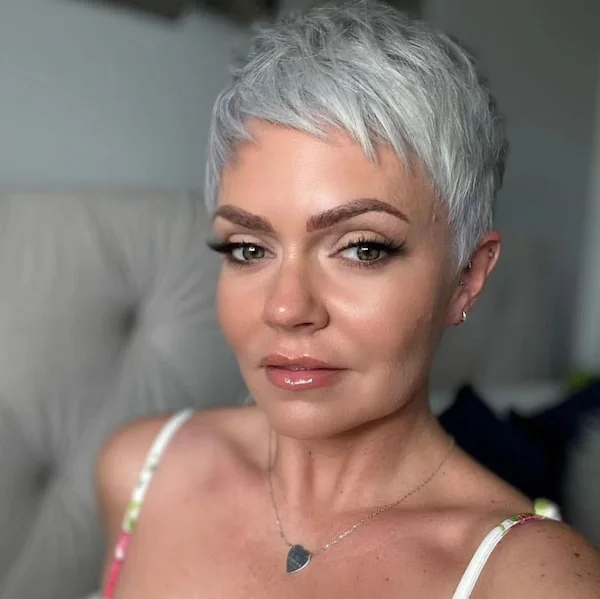silver close crop with a soft forward fringe and a clean, narrow outline on a round face with thin hair