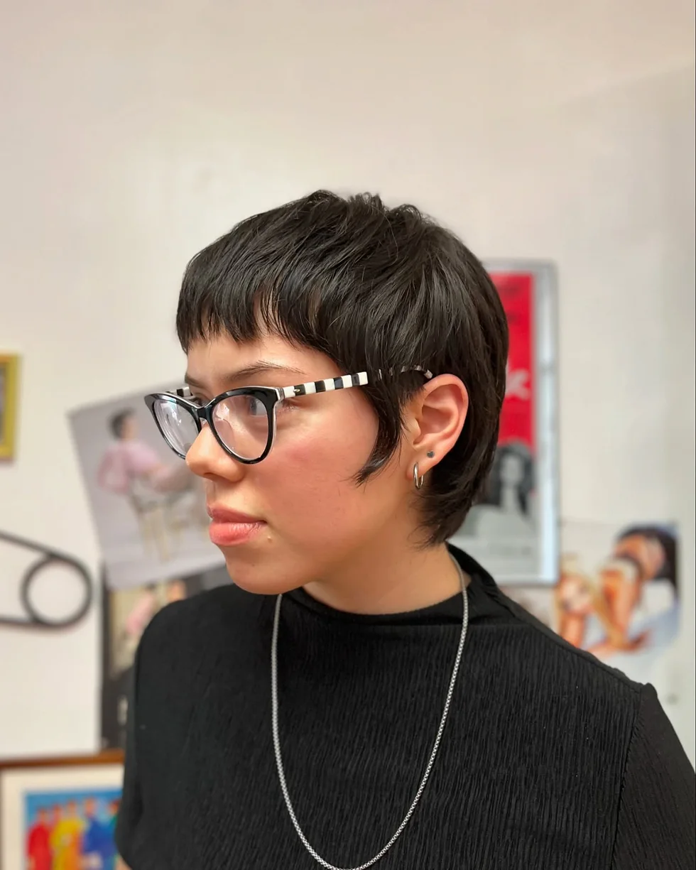 dark micro pixie with glasses, tiny bangs, and short pointed pieces at the ears on a round face with thin hair
